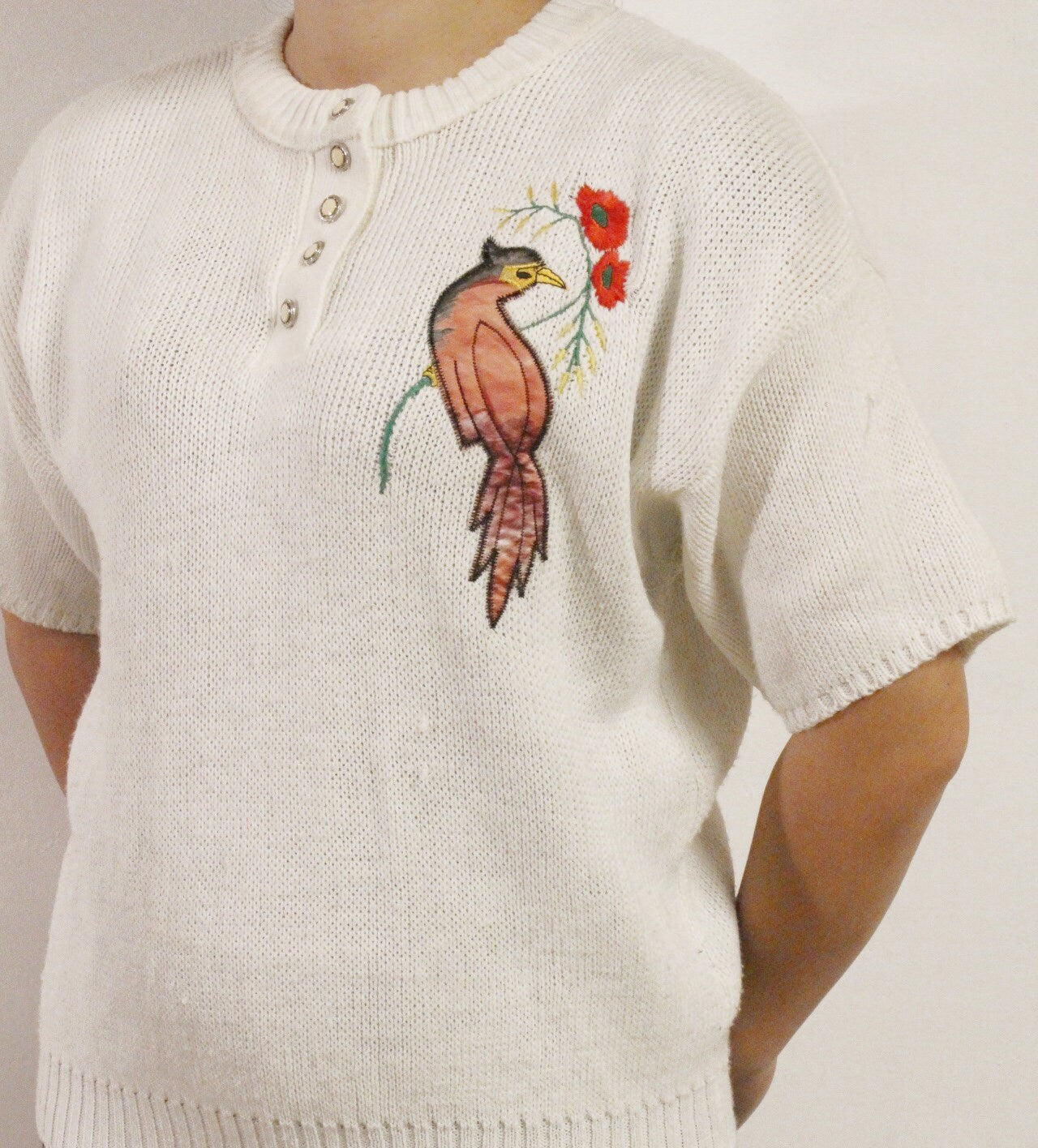 White 80s vintage knit jumper. Short sleeve womens sweater with exotic bird applique. Buttoned crew neck knitted pullover made in the UK