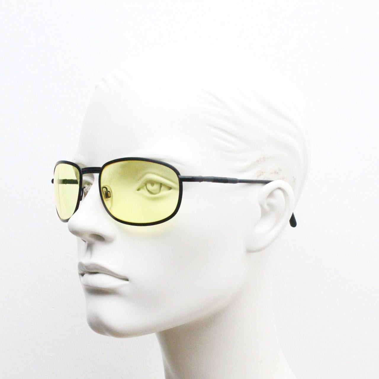 90s vintage oval bug eye sunglasses. Matt black metal frame with blazing yellow lenses and ingenious temple springs. 2000s. NOS