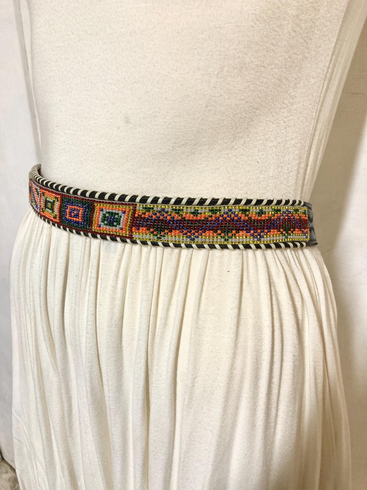 80s vintage thick Leather Native American Indian style belt. Full beaded applique, looped tape edge, embossed pattern and textured buckle