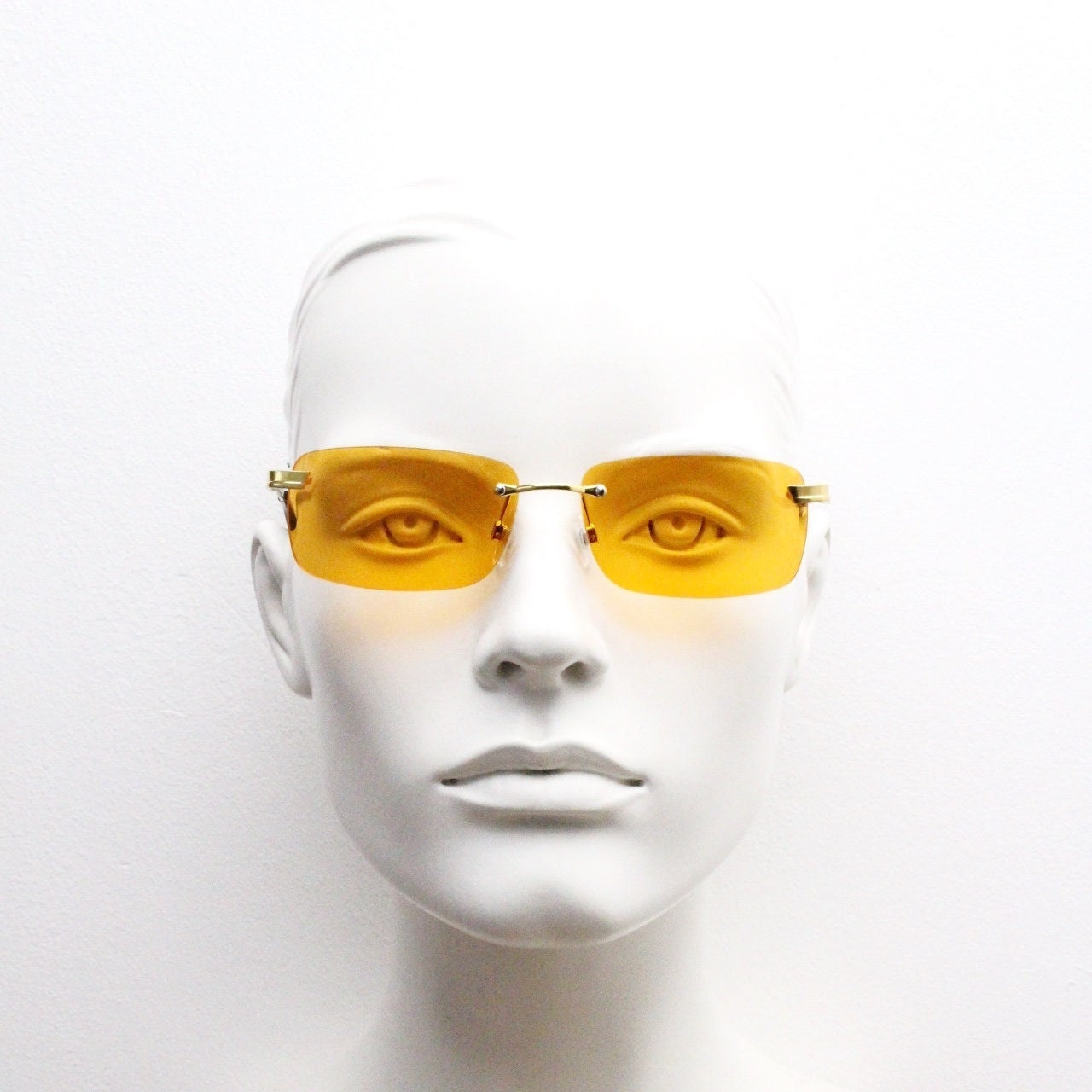 Y2K vintage frameless orange sunglasses. Rectangular lenses with gold bridge and arms. 2000s club kids. 00's. 90s Rave