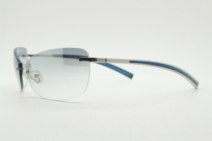 Y2K vintage wraparound sunglasses. Low profile frameless design in black matt finish with light tone graduated mirror lenses. 2000's. NOS