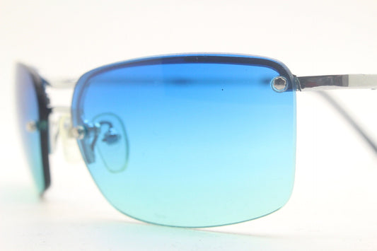 Y2K vintage visor sunglasses. Half frame wraparound shield design with light tone graduating turquoise to aquamarine lens. 2000's. 90s. NOS