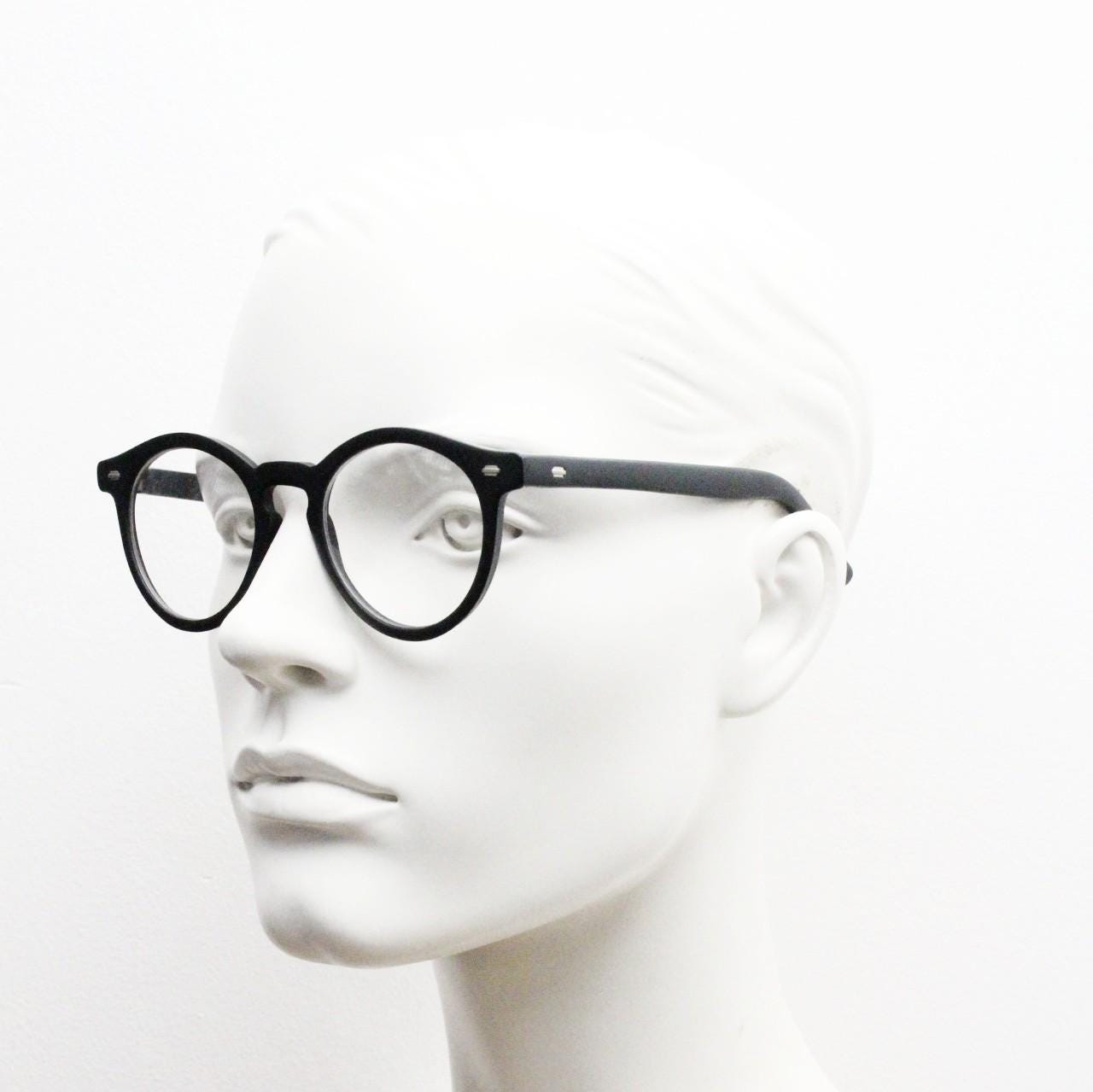 Oliver Smith round eye glasses. Black matt finish optical frames with protruding corners and keyhole bridge. Prescription RX eyeglasses