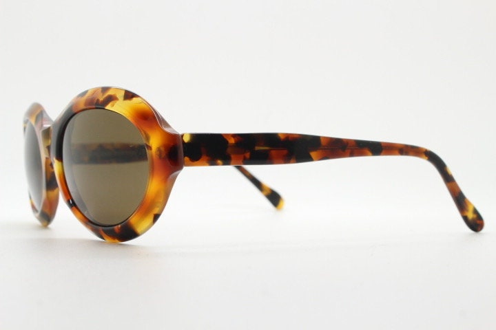 Francois Pinton Paris 90s vintage oval sunglasses made in France. Womens thick acetate frame in brown and amber tones. NOS