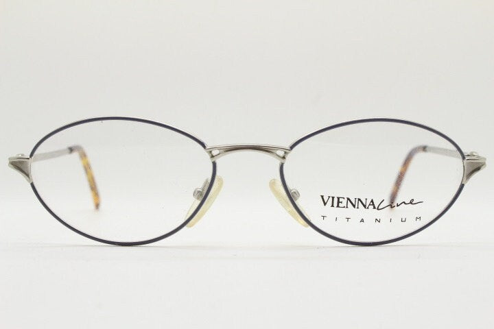 Viennaline 90s vintage oval eye glasses made in italy from titanium. Satin silver optical frame with grey enamel outline. Prescription RX
