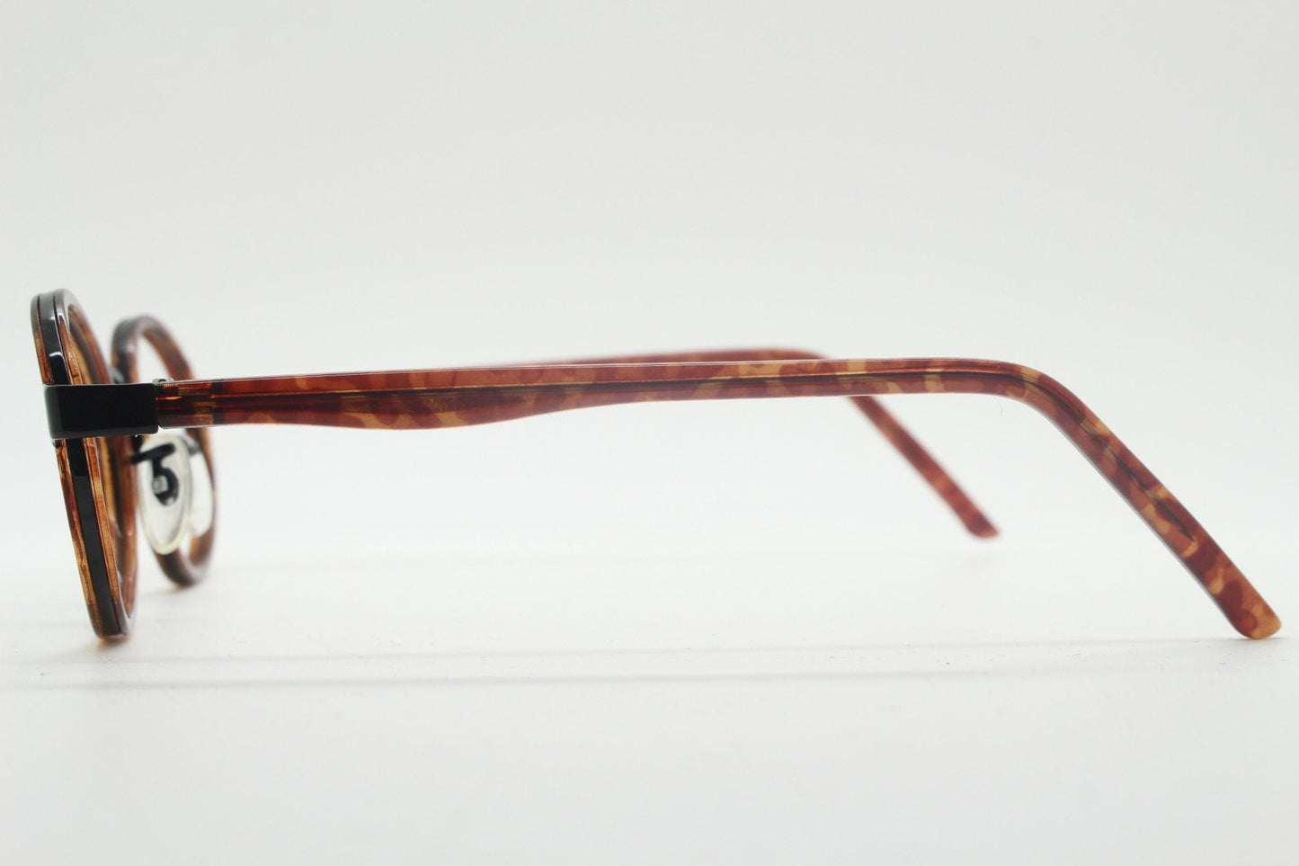 90s vintage oval glasses. Minimal slim black optical frame encasing tortoise inserts. 40s, 50s style prescription eyeglasses. RX spectacles