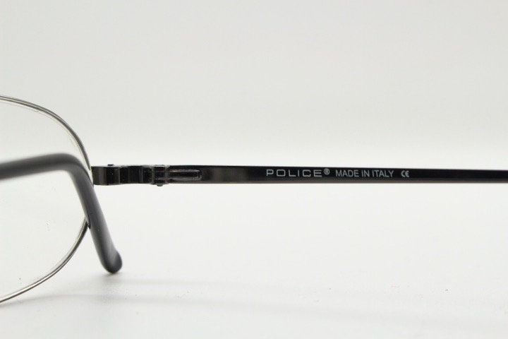 Police 90s vintage oval half rim eye glasses made in Italy. Minimal lightweight optical frame in gunmetal grey. Prescription RX Spectacles