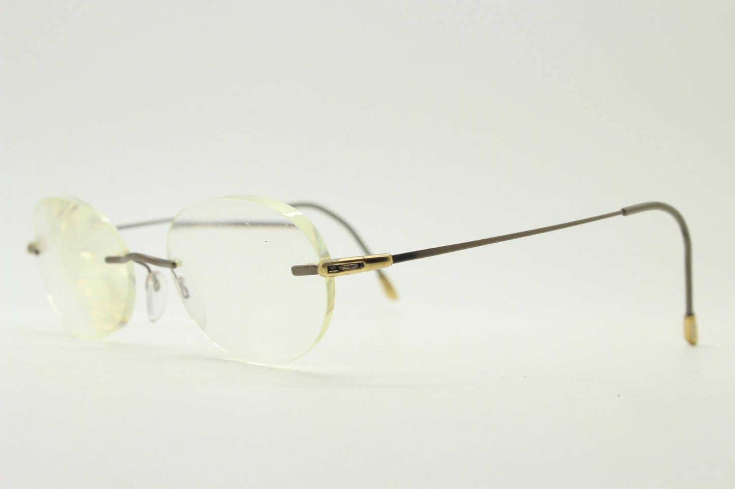 Silhouette vintage oval frameless eye glasses made in Austria. Minimal lightweight satin bronze optical frame. Prescription spectacles