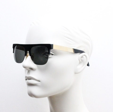Retrosuperfuture vintage flat top half frame sunglasses hand made in Italy. Black gloss acetate front with tall golden arms