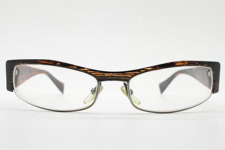 Alain Mikli 90s vintage eye glasses hand made in France. Low profile wrap around half frame in 'wood grain' acetate. Optical prescription RX