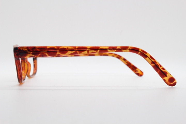 90s vintage rectangular low profile eye glasses. Transparent optical frame with vibrant amber giraffe pattern. Prescription eyeglasses. RX