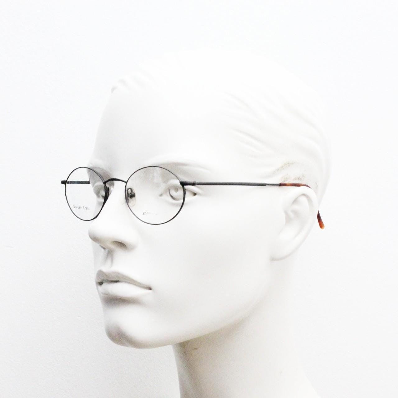Eddie Bauer 90s vintage oval eye glasses. Minimal black matt finish optical frames with kinked arms. Stainless steel spectacles. NOS