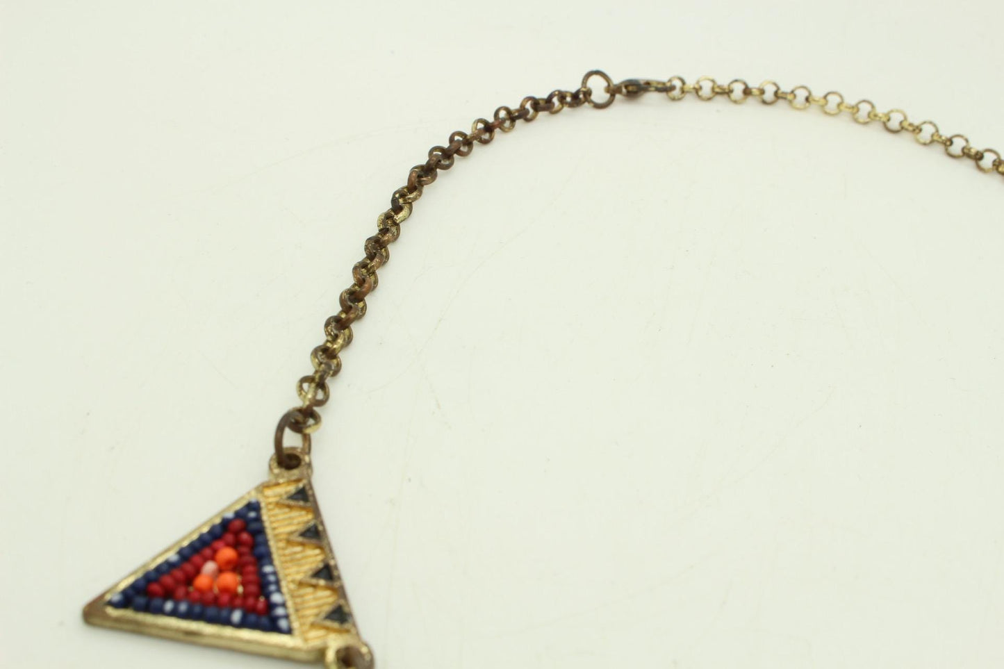 80s vintage gold triangles necklace. Aztec style with multi coloured bead inlays and ornate patterns. Womens statement design