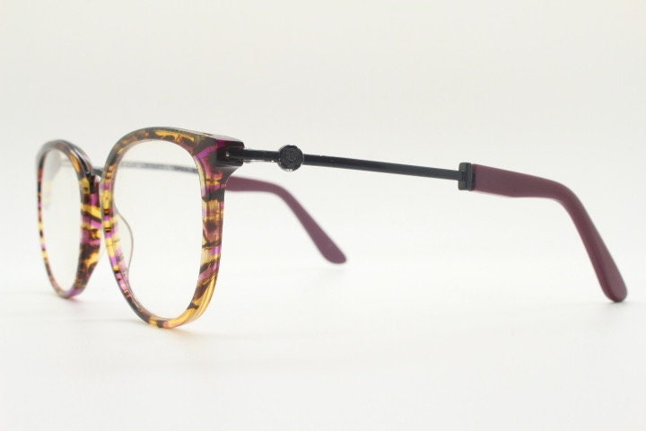 Kenzo vintage round eye glasses made in France. Tortoise with purple tones and matching arm sections. Womens Prescription Optical frames. RX