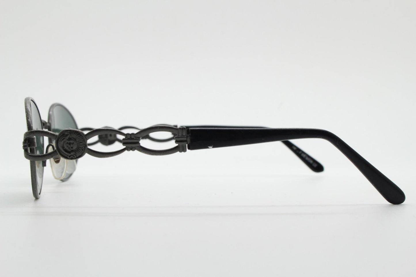 90s vintage low profile oval sunglasses. Authentic Gunmetal grey satin finish frame with chain link arm circles and real glass lenses. NOS