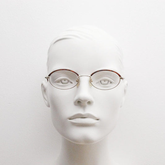 90s vintage small oval eye glasses by Tropical. Minimal gold optical frames with tortoise arms and brows. Prescription RX spectacles. NOS
