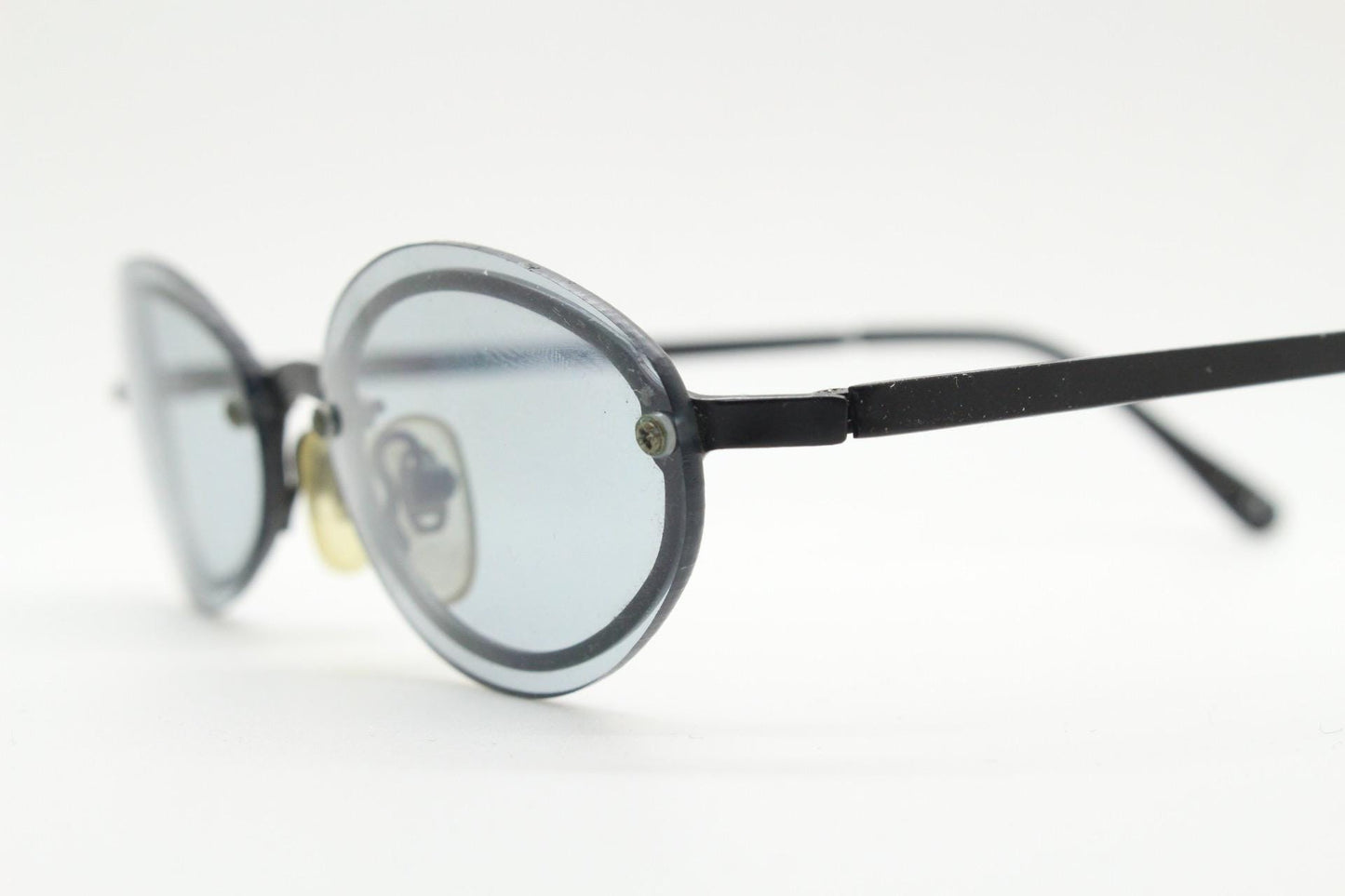 90s vintage small oval sunglasses. Minimal black metal frame with clever overlapping lens design in light tone grey. Micro. Steampunk. NOS