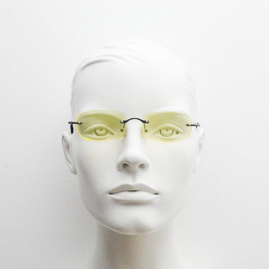 Y2K vintage frameless yellow sunglasses. Rectangular lenses with grey metal bridge and arms. 2000s club kids. 00's. 90s Rave