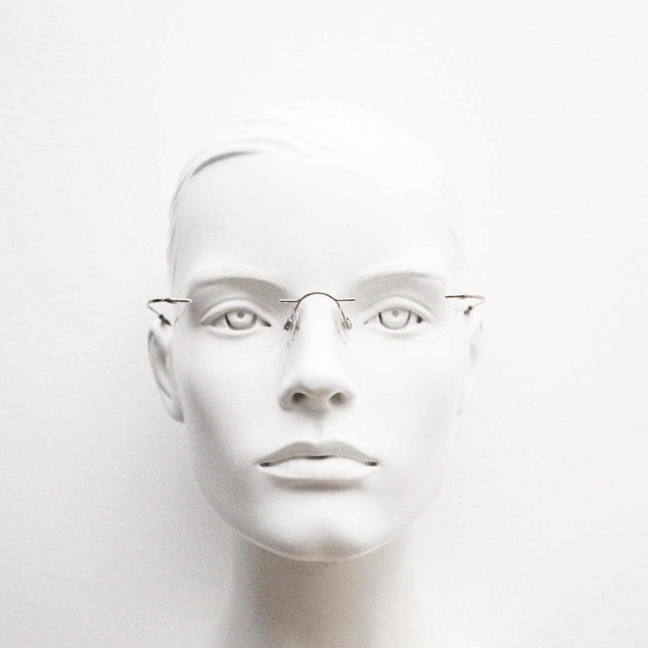 90s vintage angular oval frameless eye glasses. Minimal lightweight titanium optical frame. Flexible prescription RX spectacles
