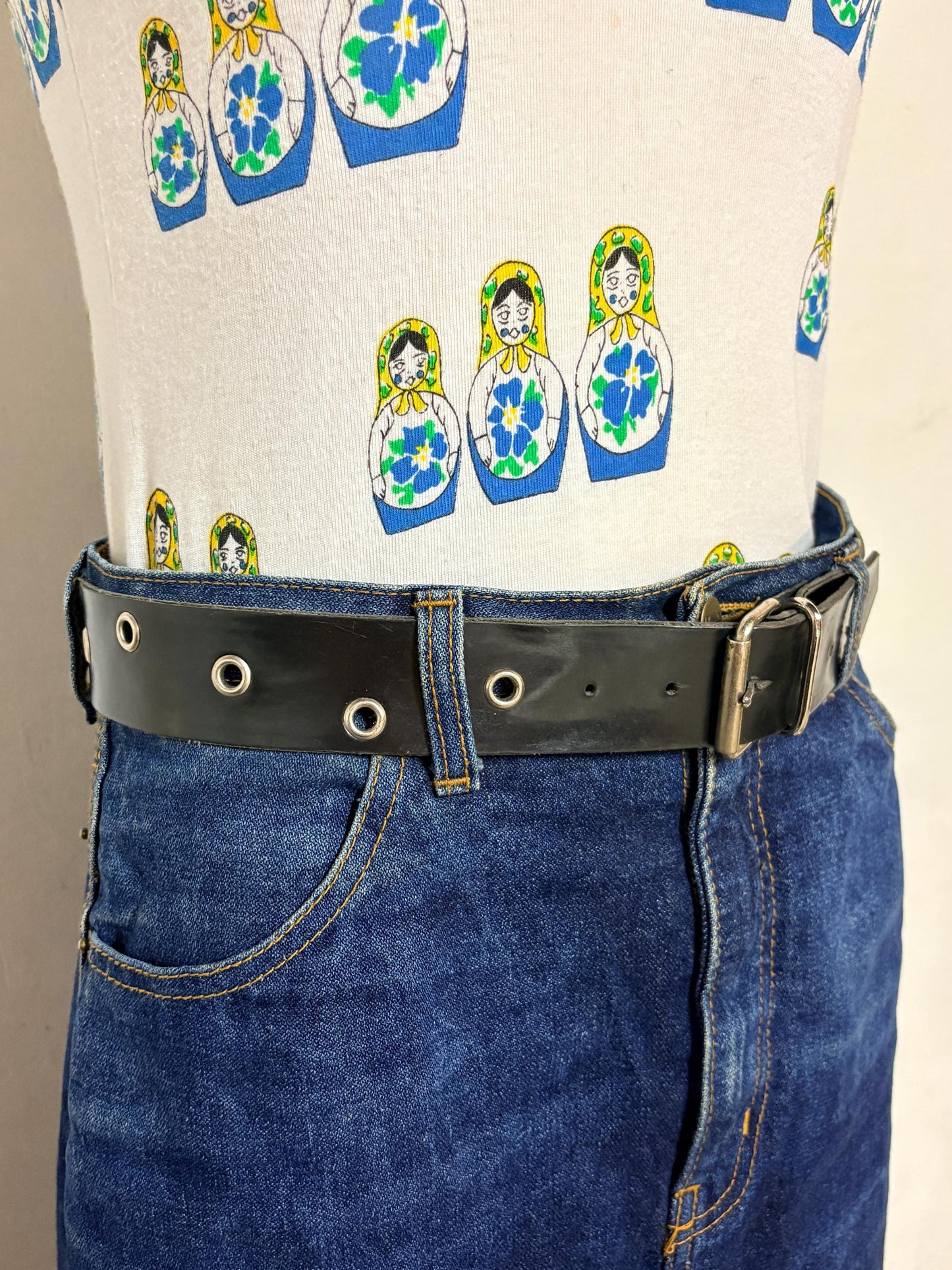 Y2k vintage womens jeans belt with silver buckle and scattered round lace holes. Thick black vinyl. Can be worn with a dress. 2000s NOS