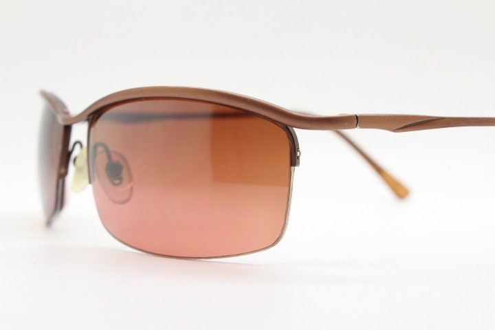 Y2K vintage curved rectangular sunglasses. Minimal half frame brow line design in brown satin finish with mid tone lenses. 2000's. 00's NOS