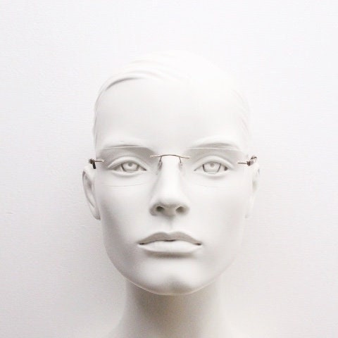 Silhouette rectangular frameless eye glasses model 7677 made in Austria. Minimal lightweight optical frame with golden trim. Prescription RX