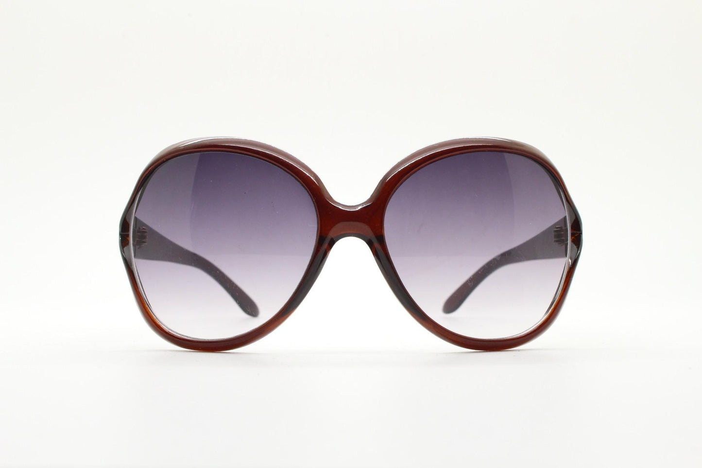 Y2K vintage big round angular sunglasses. Women's 70s design in transparent brown with graduating lenses and forked side detail. 2000s NOS