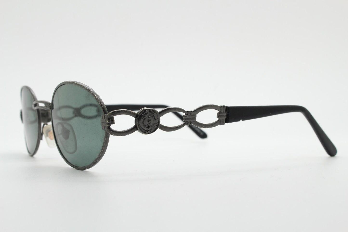 90s vintage low profile oval sunglasses. Authentic Gunmetal grey satin finish frame with chain link arm circles and real glass lenses. NOS