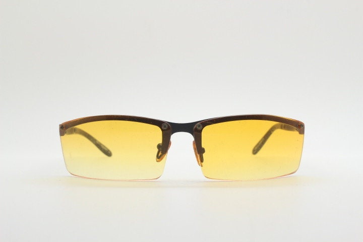 Y2K vintage half frame visor sunglasses. 2000's black brow line with light tone blazing orange rectangular curved lenses. 00's