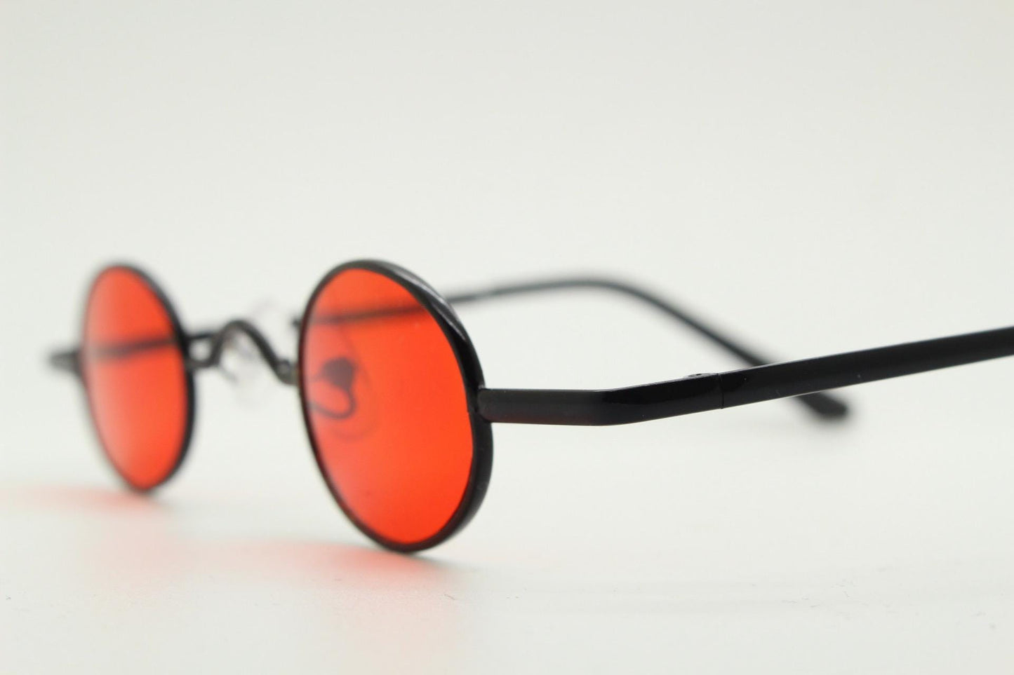 90s vintage small oval sunglasses. Imposing minimal black gloss metal victorian antique style frame with bright red lenses. Steampunk. NOS