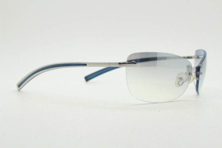 Y2K vintage wraparound sunglasses. Low profile frameless design in black matt finish with light tone graduated mirror lenses. 2000's. NOS