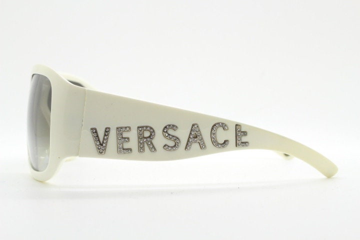 Versace Y2k vintage wrap around bug eye sunglasses. Curving white acetate shield frame with huge spell out diamante logo. 2000s. Rhinestone