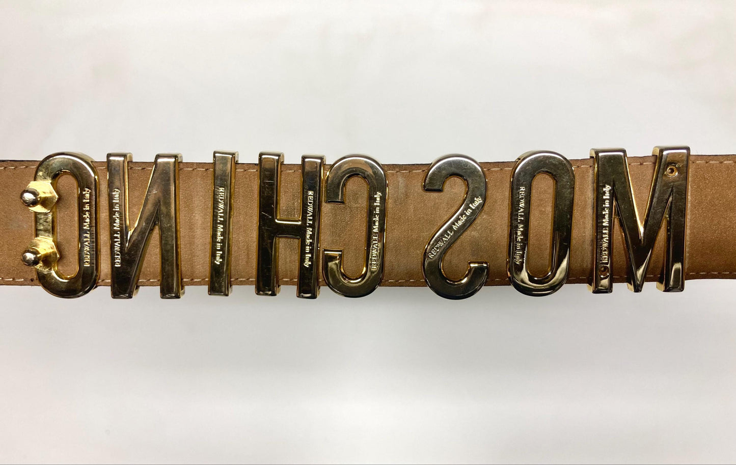 Moschino 90s vintage womens dress belt in black genuine leather. Iconic individual golden moving letters logo. Made in Italy. 80s. NOS