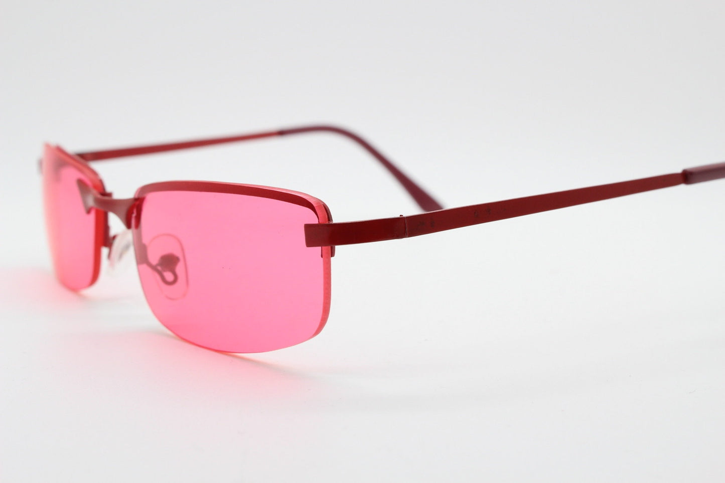 Y2K vintage half frame sunglasses with rectangular pink lenses and matching frame colours. 2000s NOS. 00's. 90s Rave
