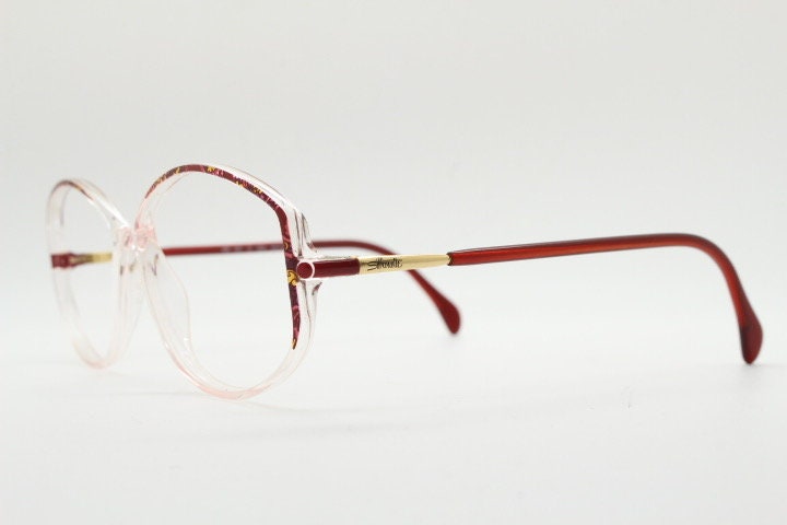 Silhouette 80s vintage hexagon eye glasses made in Austria. Transparent crystal optical frame with abstract red pattern. Prescription RX