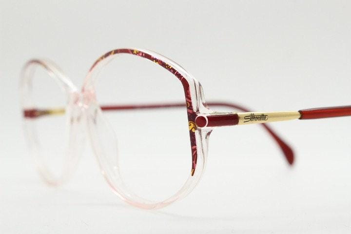 Silhouette 80s vintage hexagon eye glasses made in Austria. Transparent crystal optical frame with abstract red pattern. Prescription RX