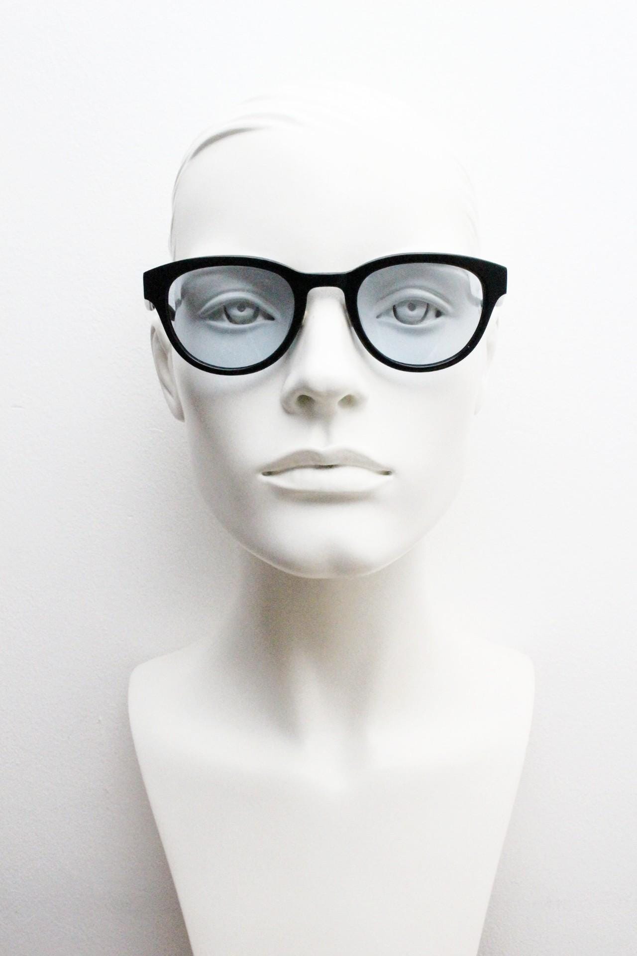 Vintage modified wayfarer design sunglasses. Black gloss acetate frame with extra light tone blue lenses in ideal proportions. NOS