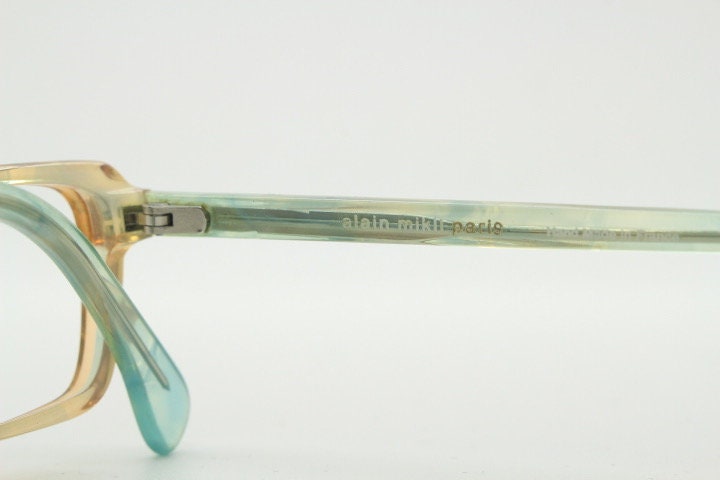 Alain Mikli rectangular eye glasses hand made in France. Low profile slim peach and blue transparent acetate optical frame. Prescription RX.