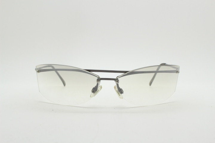 Y2K vintage wraparound sunglasses. Sick fashion grail half frame in grey chrome with extra light tone curving mirrored lenses. 2000's NOS