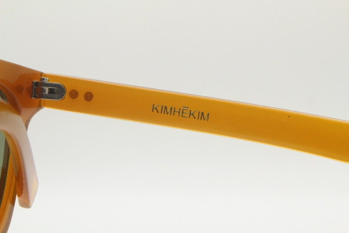 KIMHEKIM oversized wayfarer design sunglasses model J00\2. Transparent amber acetate chunky frame with 2 logo green lenses. BNWOT