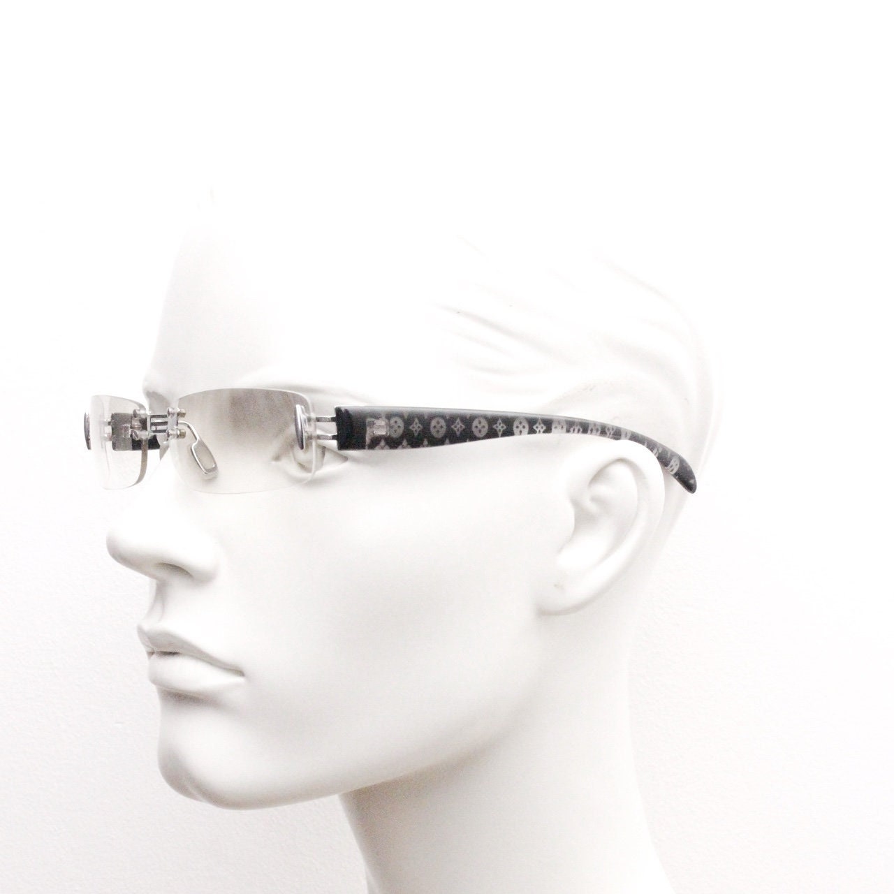 Y2K vintage frameless sunglasses. Silver chrome trim with patterned arms and extra light tone graduated curved mirror lenses. 2000's. 90s