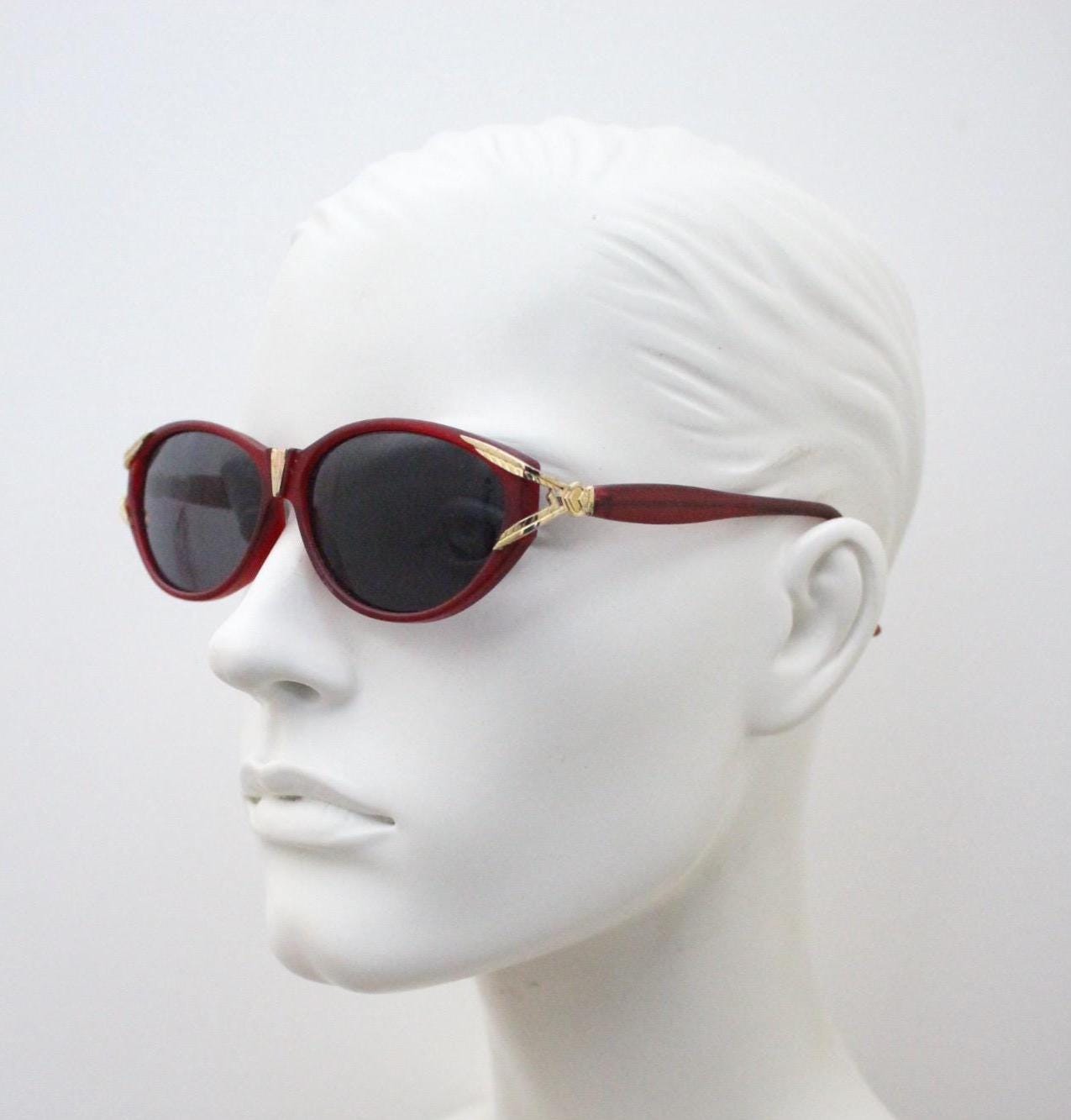 80s vintage Revlon cat eye sunglasses. Women's dark pink transparent frosted frame with golden Y fork ornate temples. 90s cateye. NOS