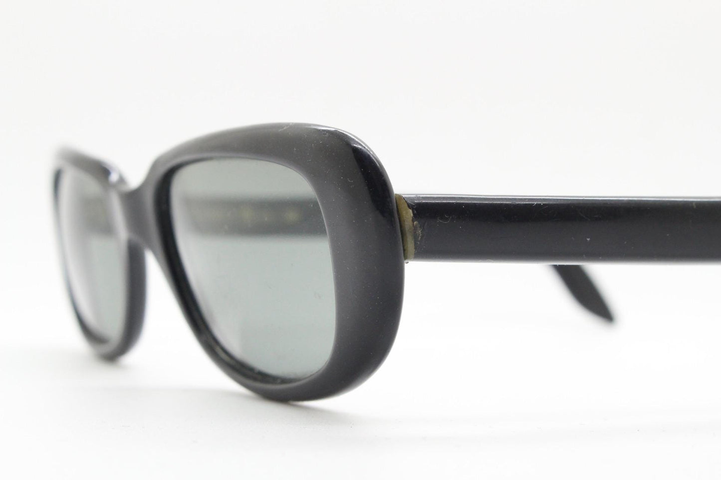 Polaroid 60s vintage rectangular sunglasses made in England. Authentic plain black frame with atmospheric curved lenses. Mens mod
