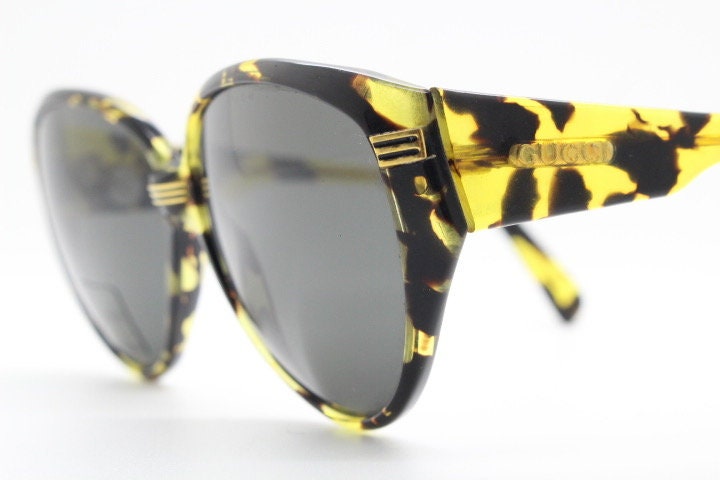 Gucci 90s vintage large oval sunglasses model 2135 made in Italy. Vibrant amber and mottled brown bug eye. NOS