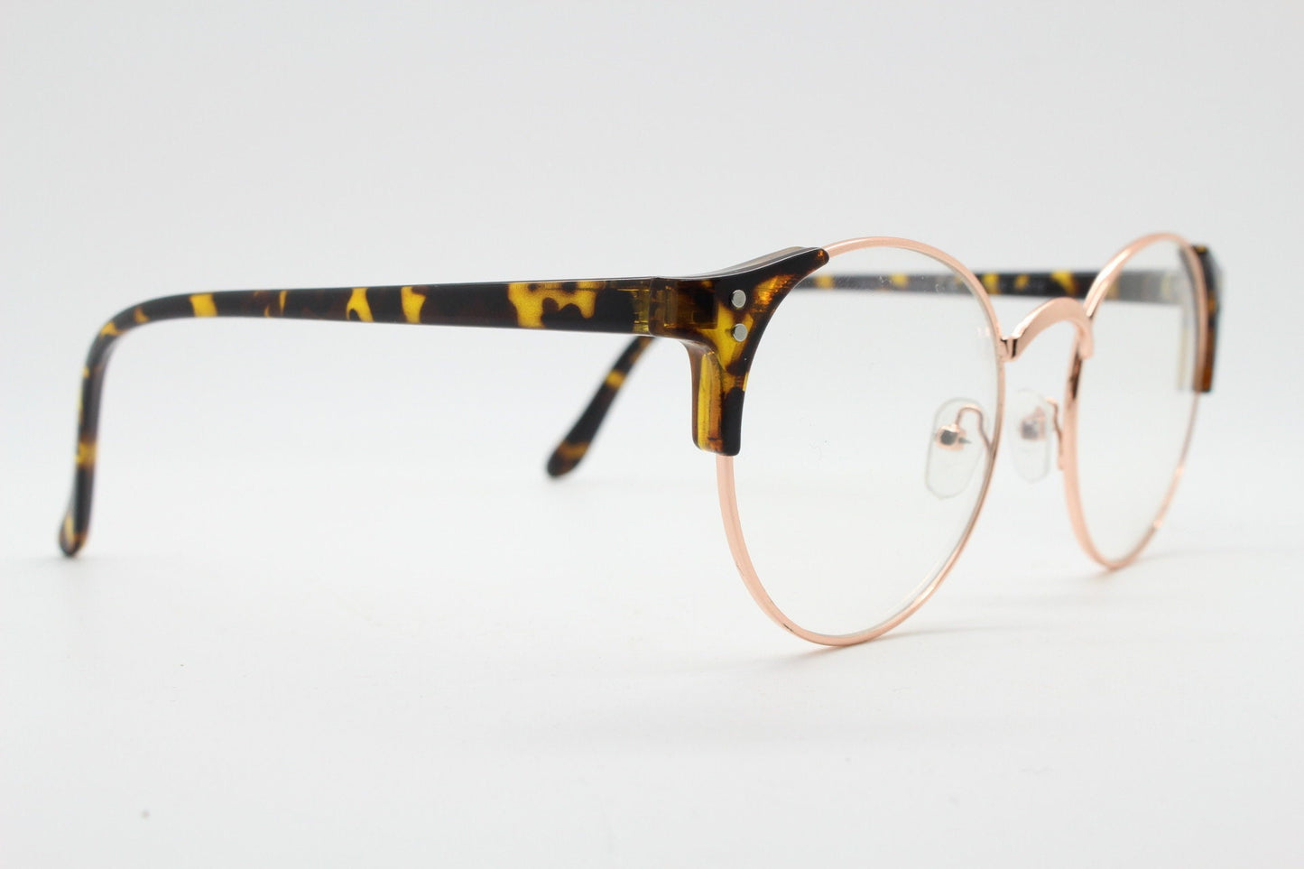 90s vintage modified cat eye glasses. Tortoise arms with a round gold face. 40s, 50s style clear lens eyeglasses. Cateye
