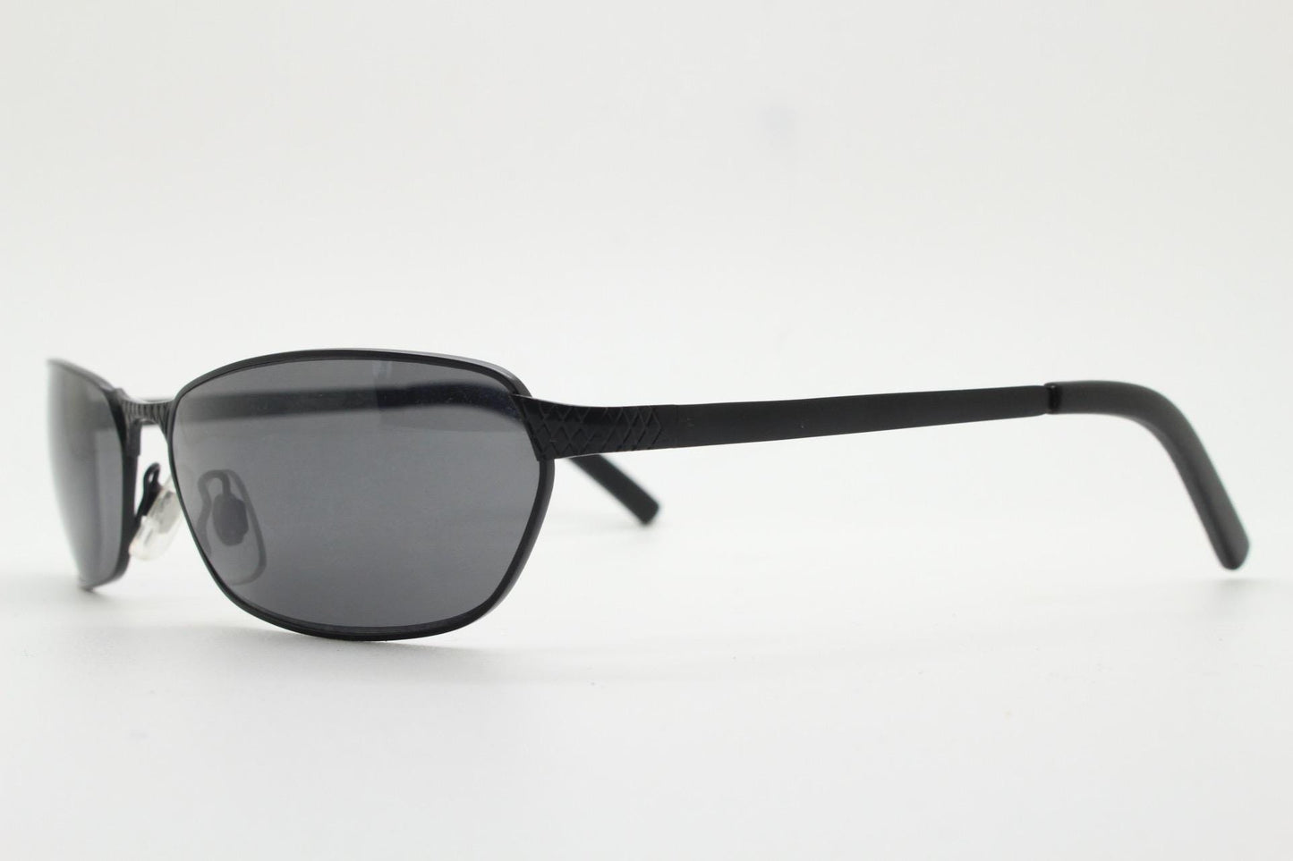 90s vintage wraparound sunglasses. Black satin finish on rectangular frame with unassuming style details. 2000's. Y2K. Unused NOS bug eye