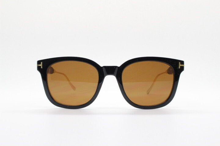 Tom Ford vintage wayfarer design sunglasses made in Italy. Slightly cat eye form in plain black gloss acetate with gold arms