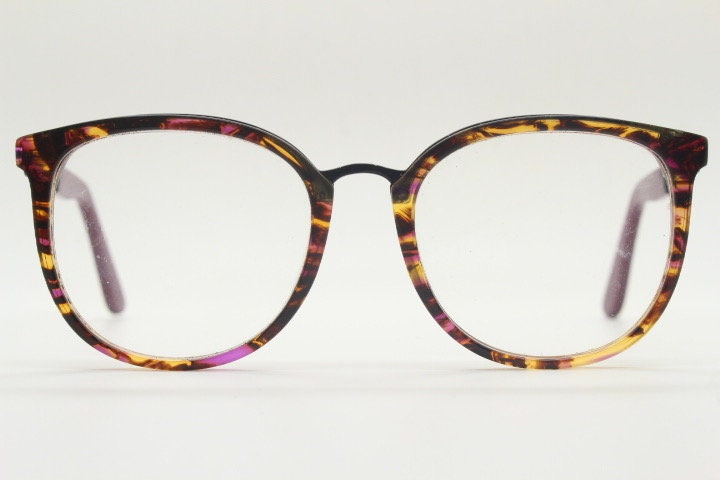 Kenzo vintage round eye glasses made in France. Tortoise with purple tones and matching arm sections. Womens Prescription Optical frames. RX