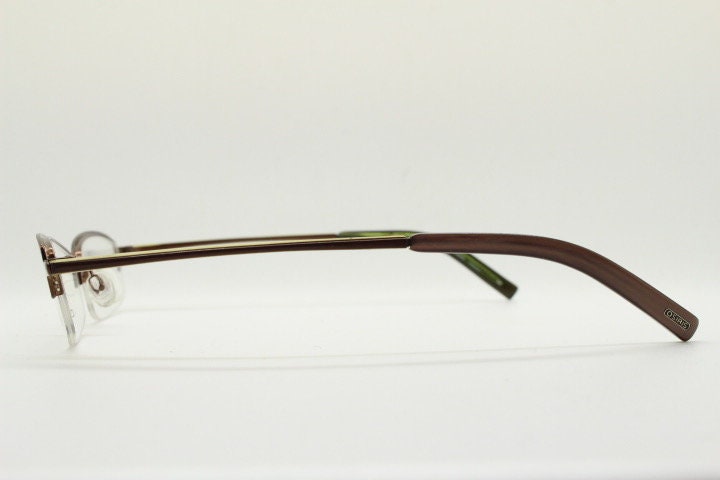 Osiris 90s vintage rectangular half rim eye glasses. Low profile optical frame in handsome brown chrome. Prescription RX Spectacles
