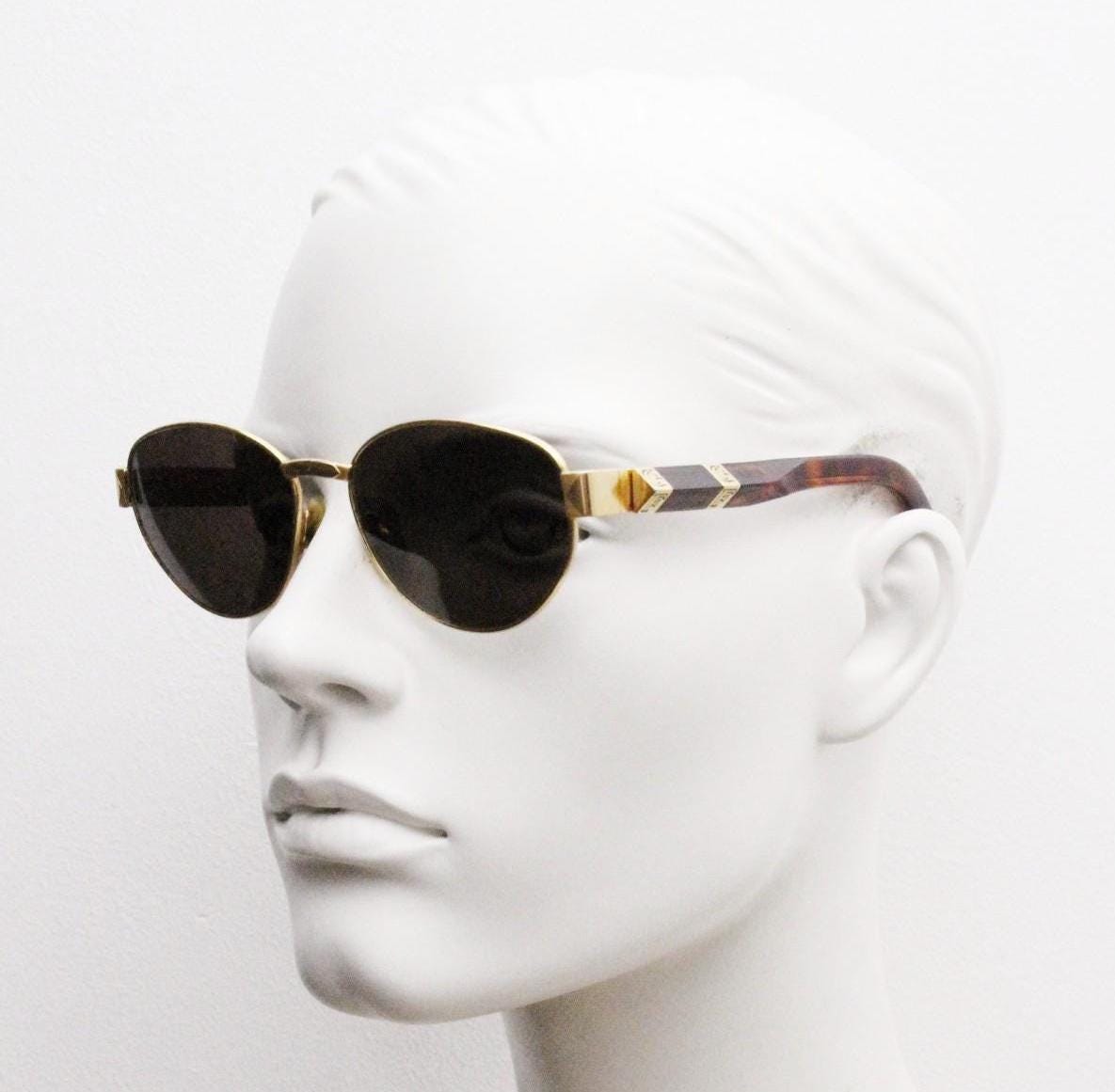 Gianfranco Ferre oval sunglasses made in Italy. Gold frame with triangular tortoise acetate arms and green lenses. 90s vintage GFF
